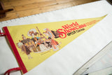 Yellow felt Vintage Epcot Center pennant, showing World Showcase characters and Eiffel Tower.