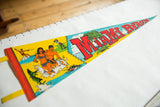 Vintage Miami Beach felt pennant graphic with swimmers, shark fin, and bold red 'MIAMI' text.