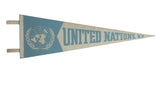 Vintage United Nations New York felt pennant, light blue emblem and text on cream, 8x25 inches.
