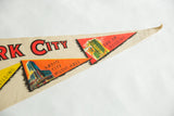 Vintage New York City felt pennant, orange Radio City and red Pan Am building flags.