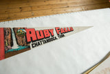 Vintage Ruby Falls pennant showing red text, waterfall illustration, and felt texture.