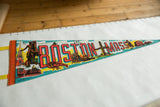 Vintage Boston Mass felt pennant with prominent red 'BOSTON' text and city landmarks.