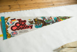 Vintage felt pennant, 'The Old Country' red text, German, French, UK flags, blue edge.