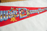 Walt Disney World logo with Mickey and friends on vintage red felt pennant.