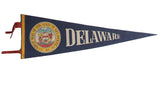 Vintage blue felt Delaware pennant with Great Seal, off-white text, yellow trim, and red ties.