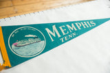 Teal felt pennant displays 'MEMPHIS TENN.' text and steamboat graphic.