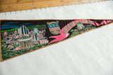 Quebec coat of arms and pink Montreal banner detail on a vintage black felt pennant.