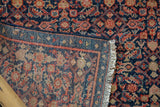 Detailed view of a vintage Malayer runner, showcasing navy, red, and beige Herati motif with fringe.