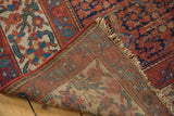 Malayer rug's hand-knotted foundation, fringe, and pile with red, blue Herati motif and wear.