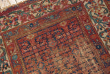 Vintage Malayer rug corner, Herati field, vine border, raspberry red, navy blue, showing wear.