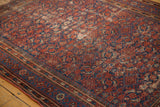 Worn vintage Malayer rug with brick red and navy Herati pattern and intricate boteh borders.