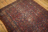 Vintage Malayer rug corner, intricate borders and worn Herati pattern, brick red and navy.