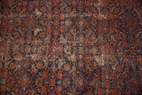 Visible foundation and worn brick red Herati motif on a vintage Malayer rug.