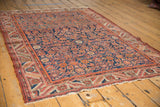 Intricate madder red and navy Herati pattern on a vintage Persian Malayer rug border.