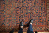 Malayer rug with worn Herati motif field, faint foundation, serrated border in madder red and navy.