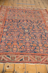 Vintage Malayer rug showcasing repeating Herati motif, intricate serrated leaf border, wear to knot heads.