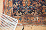 Antique Afshar tribal rug with tattered fringe and geometric rust, indigo blue border.