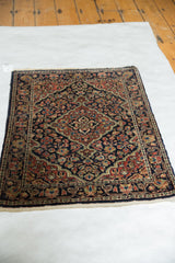 Angled full view of a vintage Persian Sarouk rug, highlighting its complex central medallion design.
