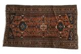 Vintage Kurdish Hamadan rug, terracotta field, geometric tribal patterns, navy blue, circa 1930s.