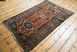 Low pile, knot heads, and terracotta shades on a vintage Kurdish Hamadan rug.