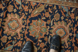 Vintage Hamadan rug detail: navy blue field with oversized terracotta and green floral motifs.