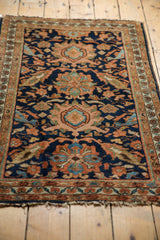 Vintage Hamadan rug detail: navy blue field with oversized floral motifs in dusty terracotta and light green.