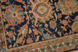 Hand-knotted Hamadan rug showing curvilinear motifs in dusty terracotta, blue, and green.