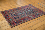 Vintage Mahal rug showcasing navy, cherry red Herati motif, Serbend border, and prominent foundation wear.