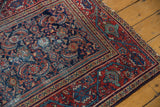 Finely woven vintage Mahal rug corner shows red Serbend border, Herati motifs, and foundation wear.