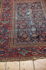 Vintage Mahal rug corner: cherry red Serbend border, navy Herati field, with visible foundation.