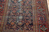 Vintage Mahal rug's navy Herati motif field and classic red Serbend border with foundation wear.