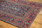 Vintage Mahal rug's fine Herati motif, navy field, cherry red border, and visible foundation wear.
