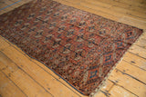 Tekke rug's 'elephant footprint' gul motifs in dusty brick red, navy, and ivory.