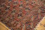Low pile showing knot heads on an antique Tekke rug with dusty brick red gul motifs.