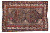 Antique Qashqai rug, double geometric medallion, allover tribal field, madder red, navy blue, mostly even wear.