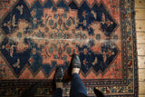 Vintage Malayer rug's navy blue field, hard wear, and wave and floral border.