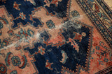 Malayer rug, navy and blush floral pattern, with foundation showing from hard wear.