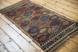Geometric gul motif on an antique Persian Belouch runner in copper beige and nuanced blues.