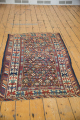 Collector's antique Caucasian rug corner, navy, rose, ivory geometric patterns, secured end.