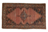 Blush rose Vintage Malayer rug with diamond medallion, navy floral corners, showing mostly even wear.