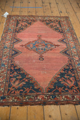 Vintage Malayer rug's navy blue corner spandrel with oversized floral motifs and pile wear.