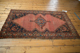 Vintage Malayer rug with abrashed blush rose field, cobalt spandrels, and mostly even wear.