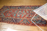 Wider deep blue main border and geometric field with low pile on a vintage Heriz.