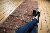 Vintage Heriz runner's unique Herati motif with low pile in brick red and blue.