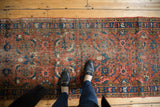 Heriz runner's brick red, navy blue Herati pattern, low pile, and side selvage.