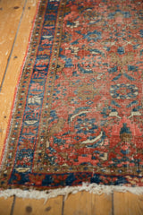 Heriz runner's intricate Herati pattern, mostly low pile with visible foundation, ivory fringe.