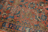 Vintage Heriz runner's Herati pattern, low pile, and blue border details.