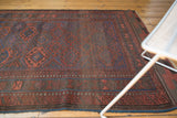 Geometric patterns of antique Belouch rug with low pile in madder red and indigo.