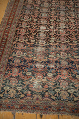 Antique Malayer rug close-up: intricate charcoal boteh, vinery, and overall soft wear.