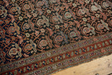 Antique Malayer rug's intricate charcoal boteh and lattice vinery with vibrant red border.